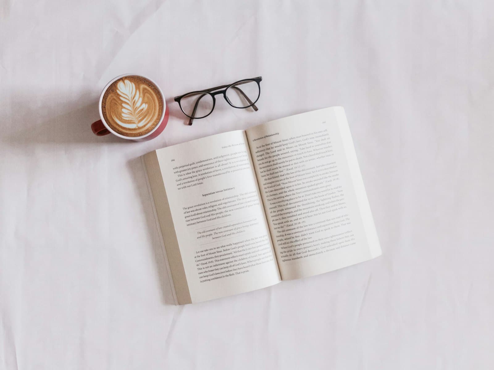 Stack of books beside headphones